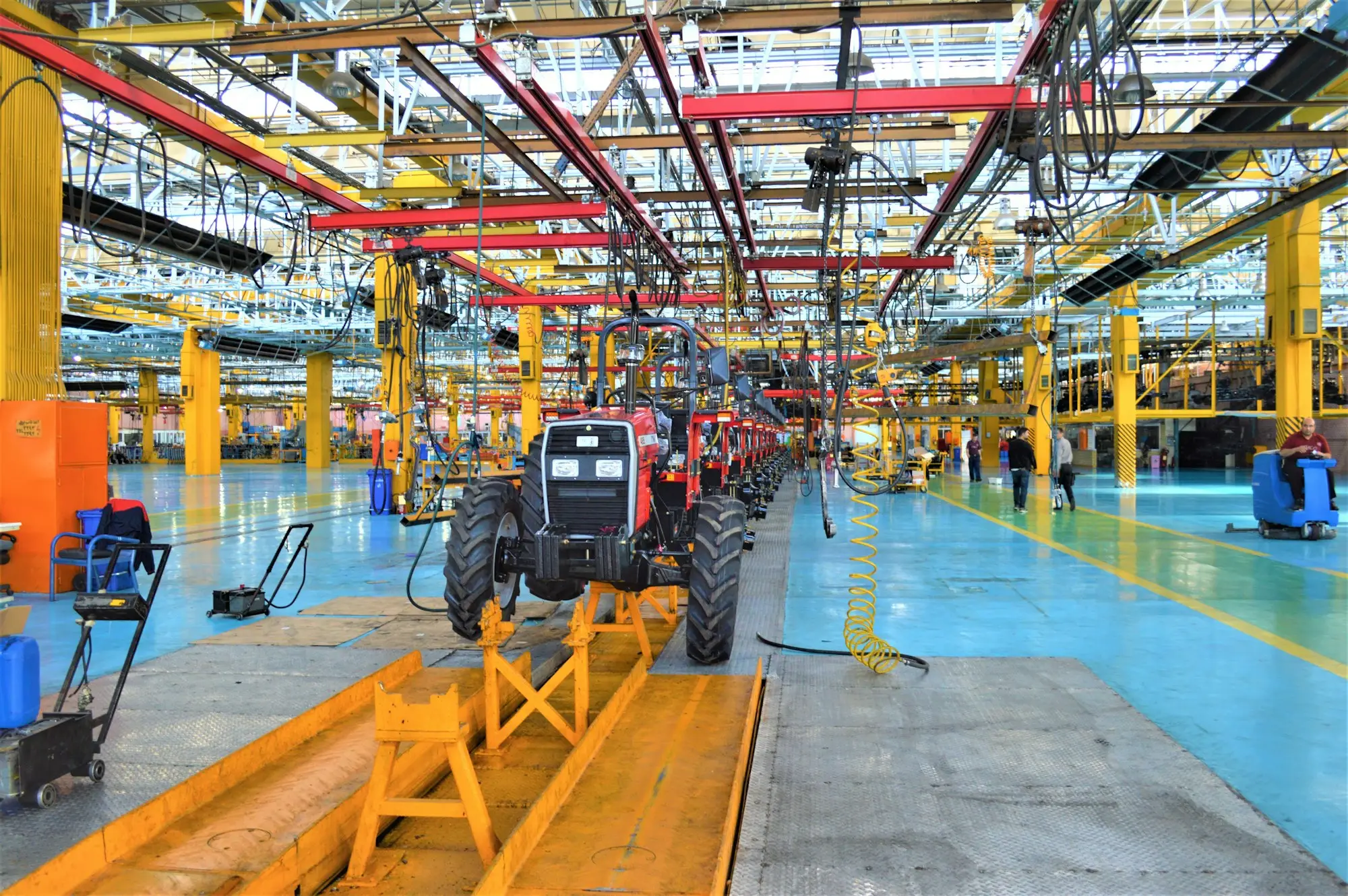 Tractors moving down a factory assembly line, the kind of manufacturer that invoices dealers on 30 to 60 day terms