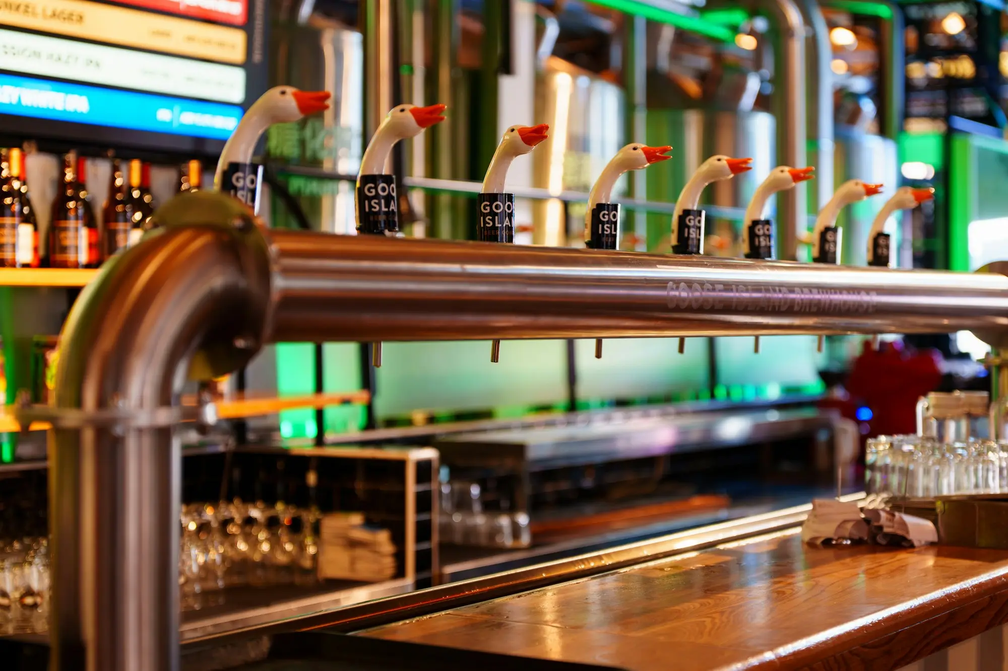 Row of beer taps along a pub bar counter, the kind of business that is paid at the till before suppliers are